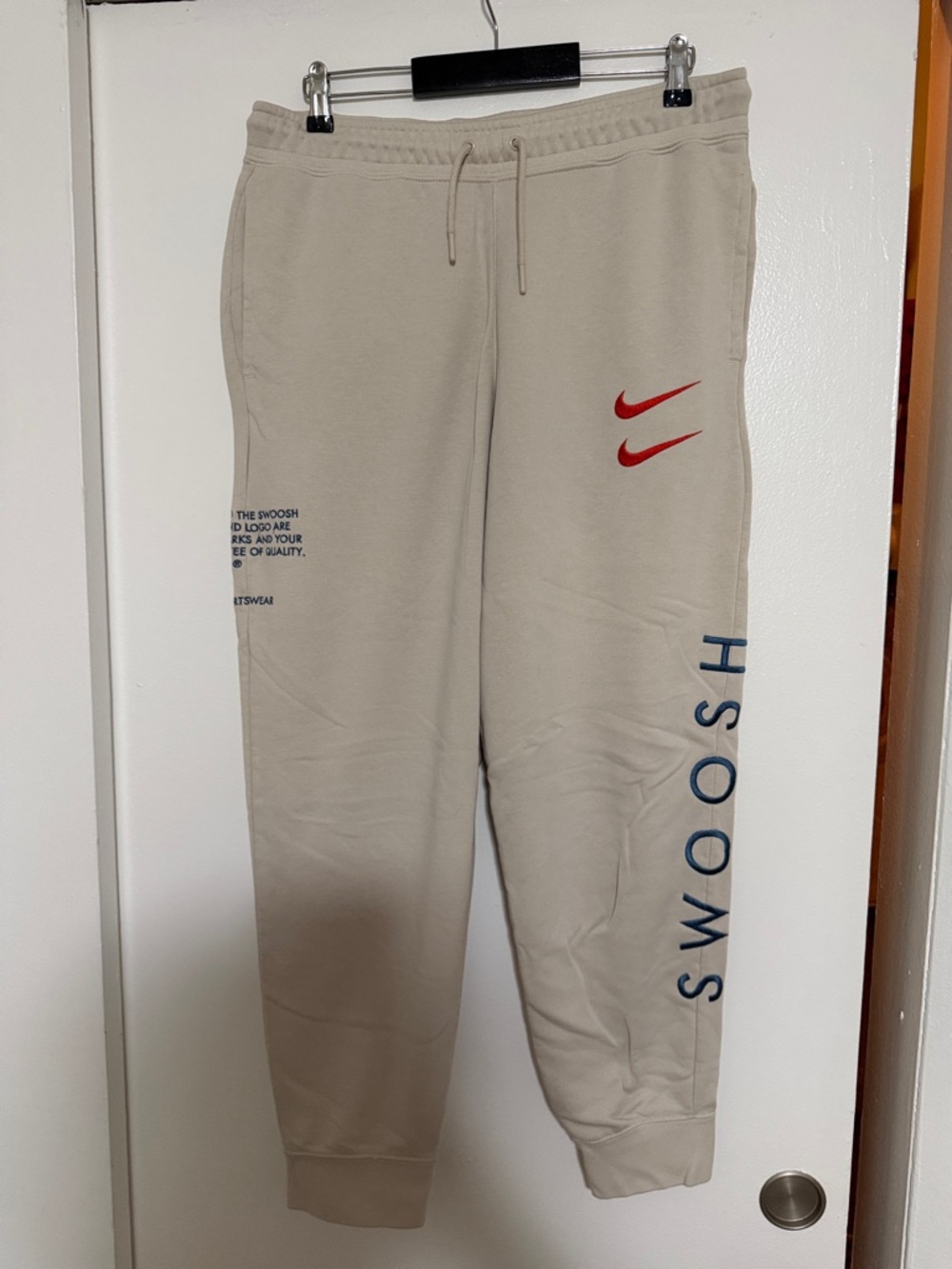 Men’s Large Like New Nike Beige Joggers with Red Swoosh and Navy 'SWOOSH' Text